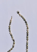 Detail of green pearls and gold-filled accents on the Clove necklace
