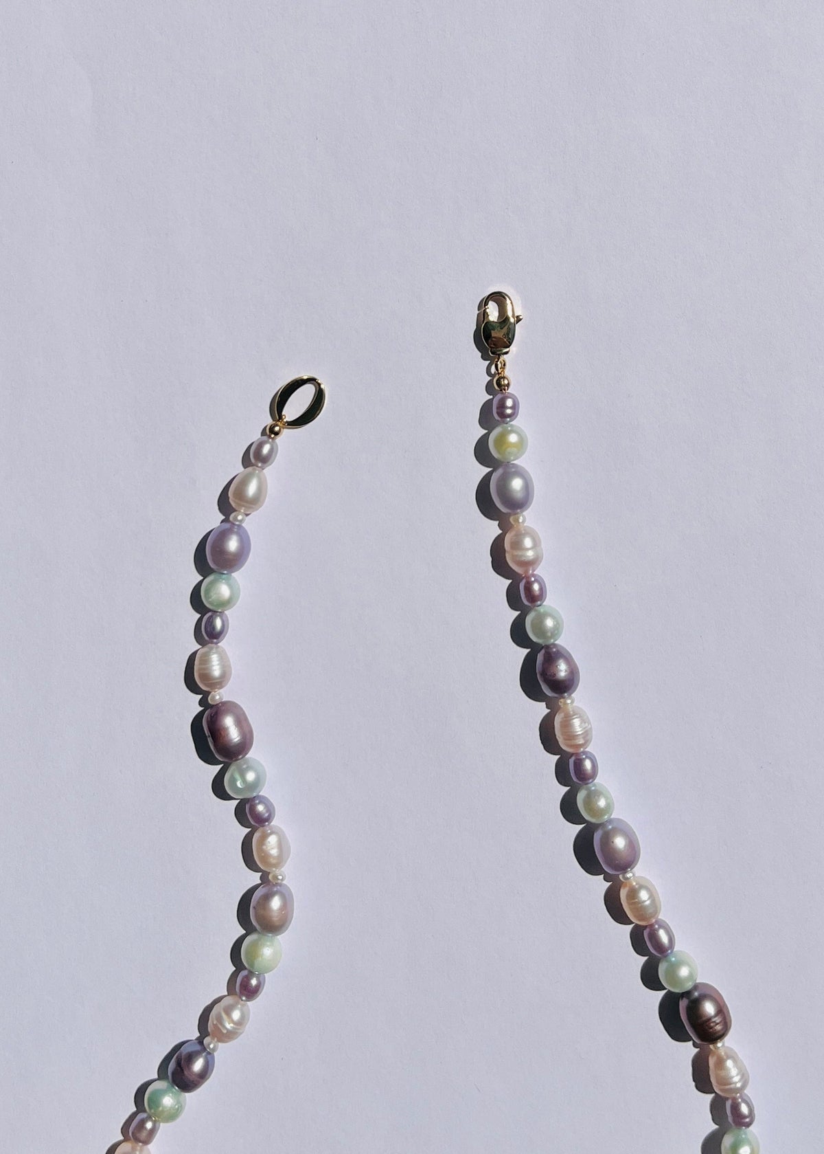 Detail of sea foam blue and lavender pearls and gold-filled accents on the Faye necklace