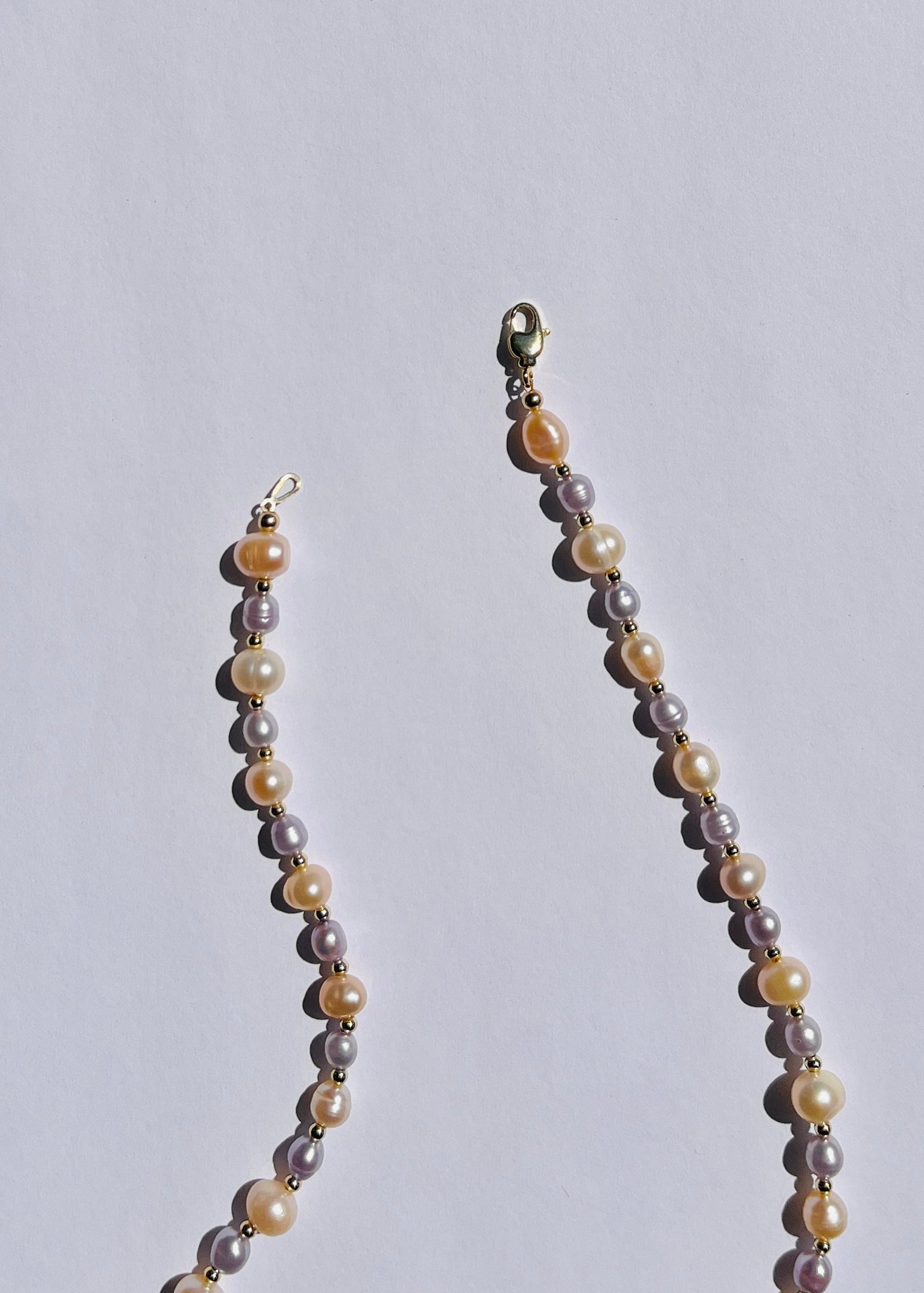 Detail of peach and lavender pearls and gold-filled accents on the Flora necklace