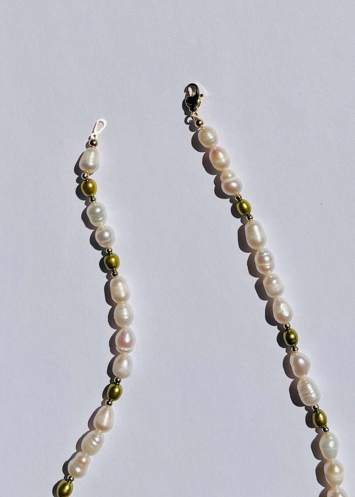 Detail of white and olive green pearls and gold-filled accents on the Olive necklace