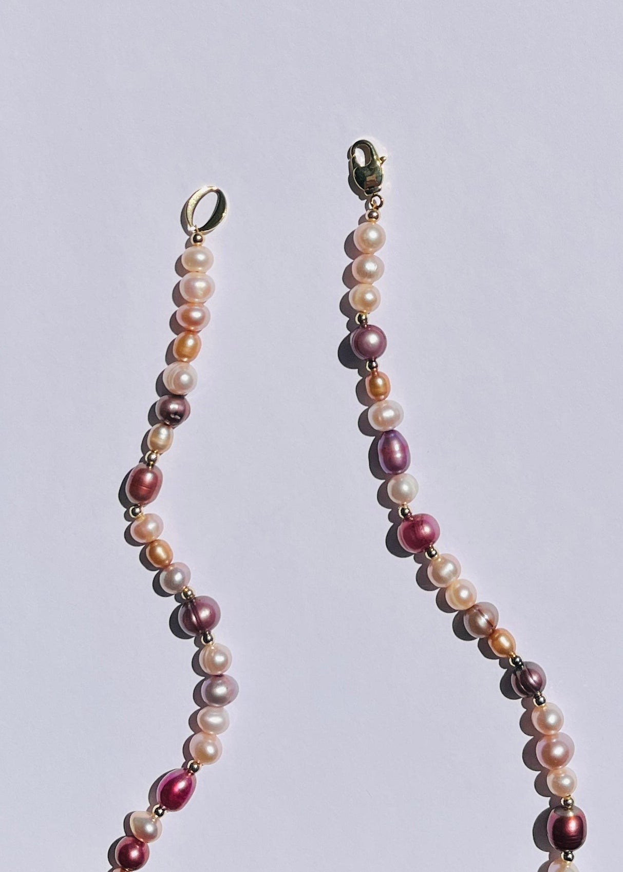 Detail of pink and mauve warm-toned pearls and gold-filled accents on the Sakura necklace